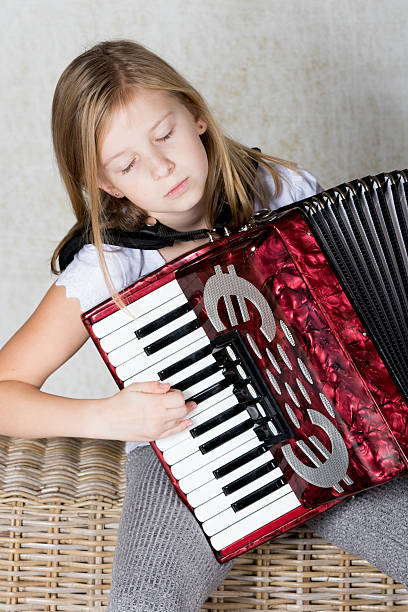 istock Girl focused on playing the accordion 620384098