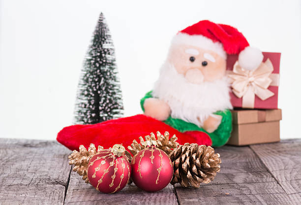 istock Santa Claus toy leaning against gift boxes 620384952