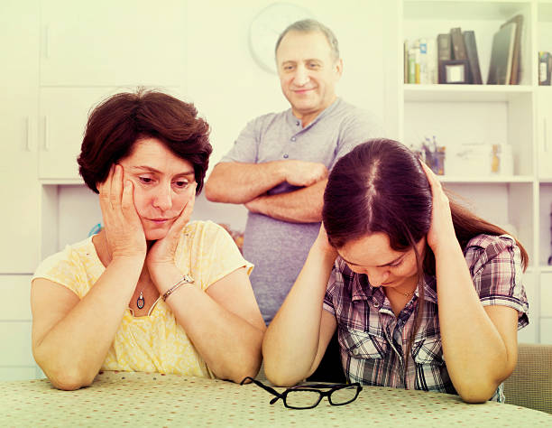 istock Young woman talking to mature parents 620386032