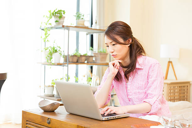 istock Japanese woman using a laptop 620388122