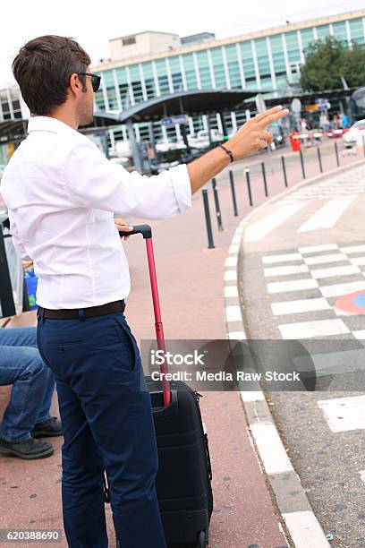 Business Man Expects A Taxi At The Airport Stock Photo - Download Image Now - Adult, Airplane, Airport