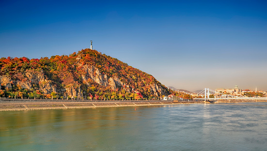 The Gellert Hill (Hungarian: Gellért hegy) and the Elisabeth Bridge  (Hungarian: Erzsébet híd) over the Danube river  in Budapest (Hungarian: Duna) at autumn.