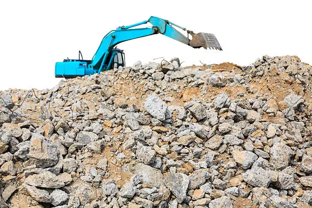 pieces of concrete and brick rubble debris on construction site with loader on white background