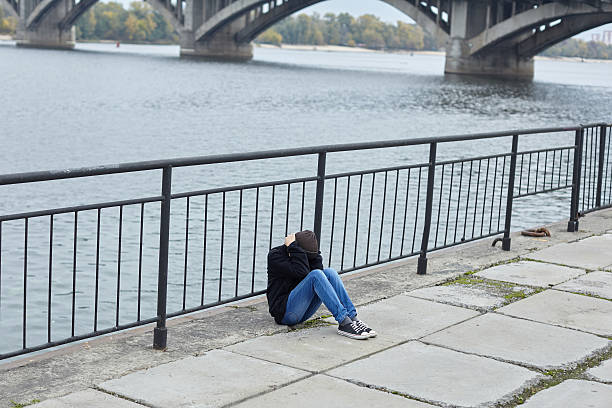 istock young homeless boy sleeping on the street 620389638