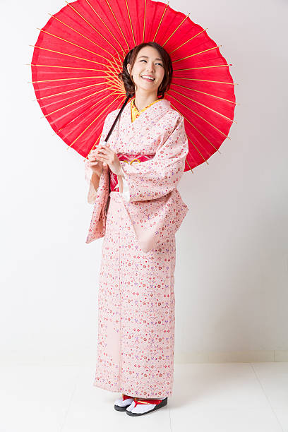 istock Woman wearing a kimono with a red umbrella 620389652