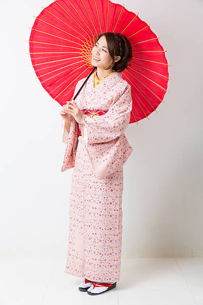 istock Woman wearing a kimono with a red umbrella 620389696