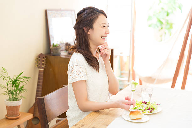 istock Japanese woman eating salad and bread 620389880