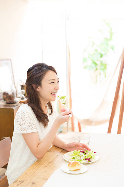 istock Japanese woman eating salad and bread 620389904