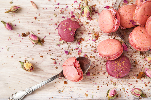 Pink macaroon on a wooden table