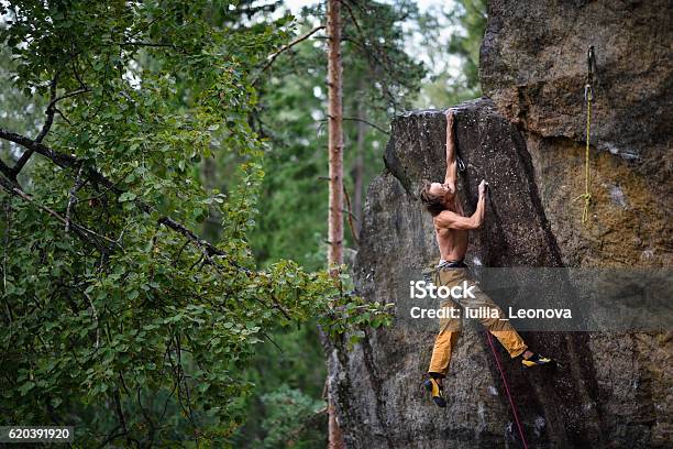 Extreme Sport Climbing Young Male Rock Climber Stock Photo - Download Image Now - Hanging, Mountain Climbing, Achievement