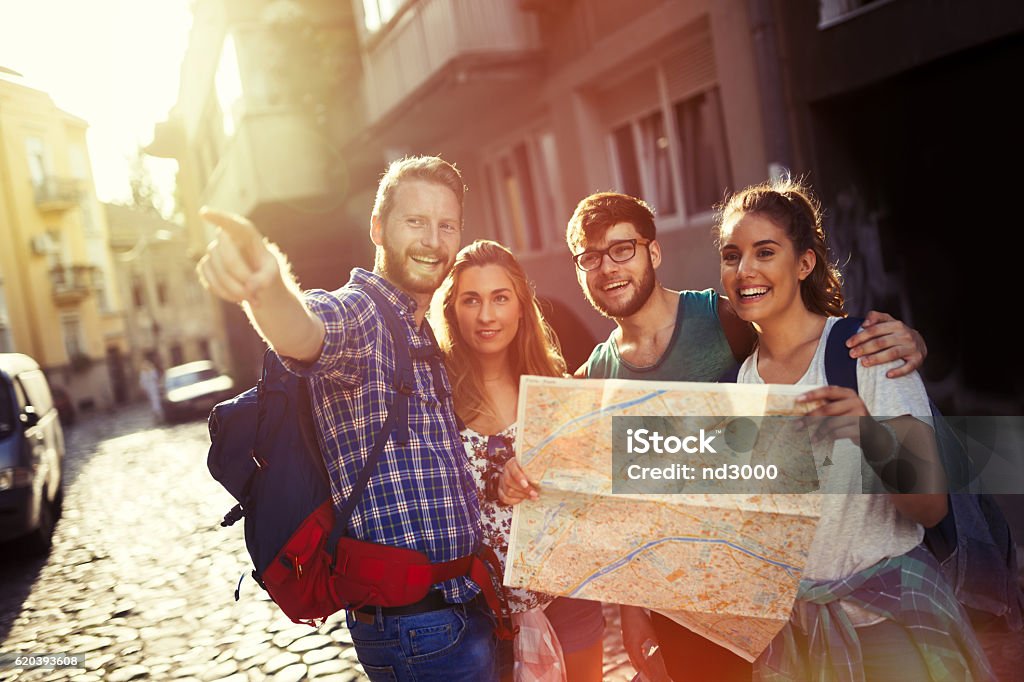 Happy tourists exploring city Happy tourists exploring travel destination city Guide - Occupation Stock Photo