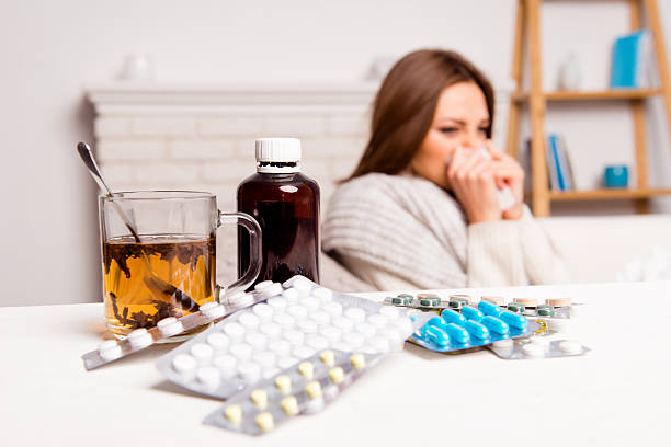 istock cup of tea, pills and mixture. sick woman's treated 620394306