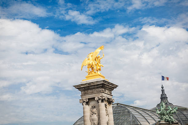 istock gold colored sculpture on the top of stone pillar 620395372