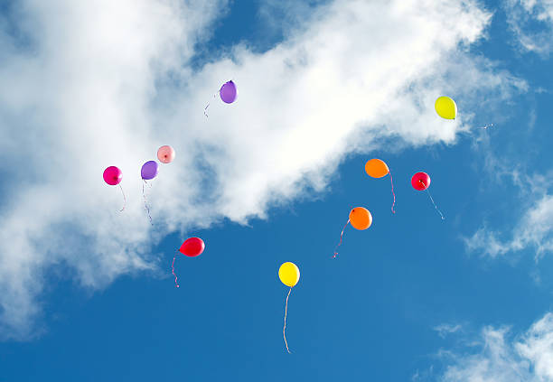 istock Many colorful baloons in the blue sky. 620395410