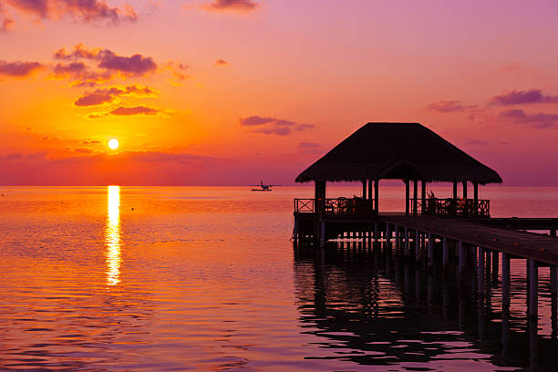 Water cafe at sunset - Maldives vacation background