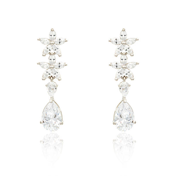 istock Pair of silver diamond earrings isolated on white 620396844