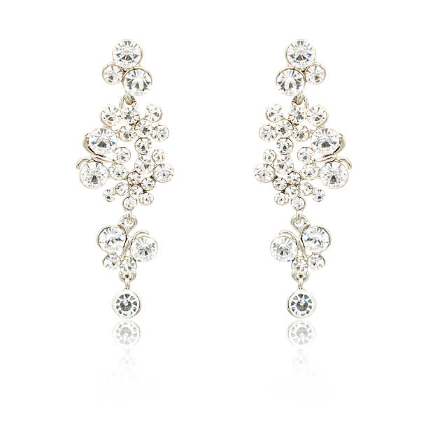 istock Pair of silver diamond earrings isolated on white 620396898