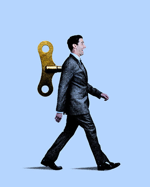 Happy Businessman Walking With Wind Up Key In His Back