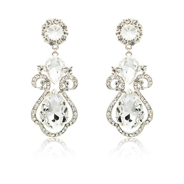 istock Pair of silver diamond earrings isolated on white 620398012