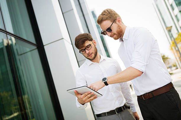 istock Businesspeople looking at tablet 620398124