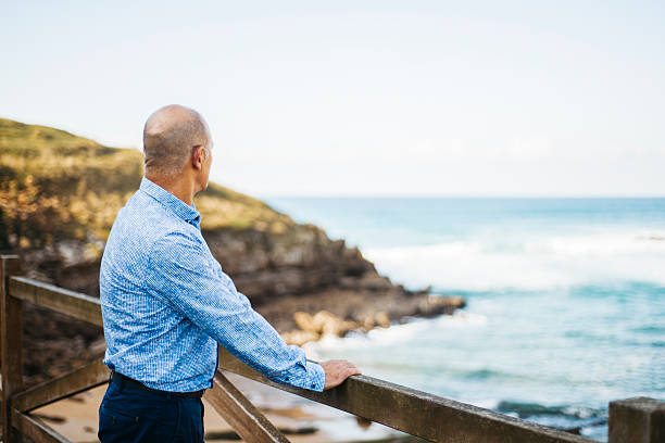 istock Mature man looking at the sea 620398142