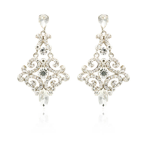 istock Pair of silver diamond earrings isolated on white 620398178