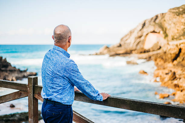 istock Mature man looking at the sea 620398232