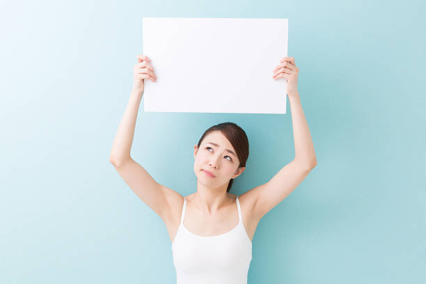 istock Woman holding a blank sign 620398272