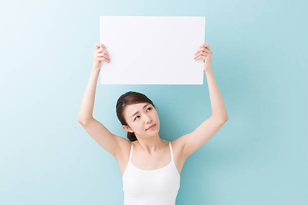 istock Woman holding a blank sign 620398320