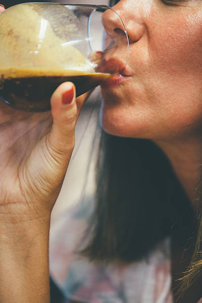 istock Woman drinking coffee from wine glass 620398722
