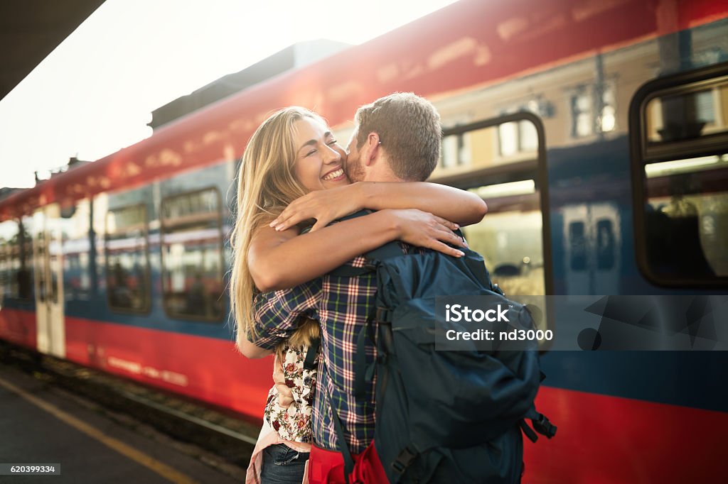 Beautiful couple hugging after long journey Beautiful couple hugging after long separation Train - Vehicle Stock Photo