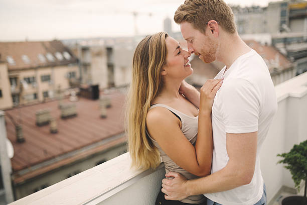 istock Sensual couple rooftop romance 620399876