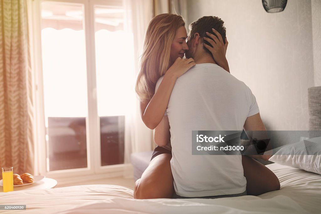 Beautiful romantic couple foreplay Beautiful romantic couple foreplay in bed Women Stock Photo