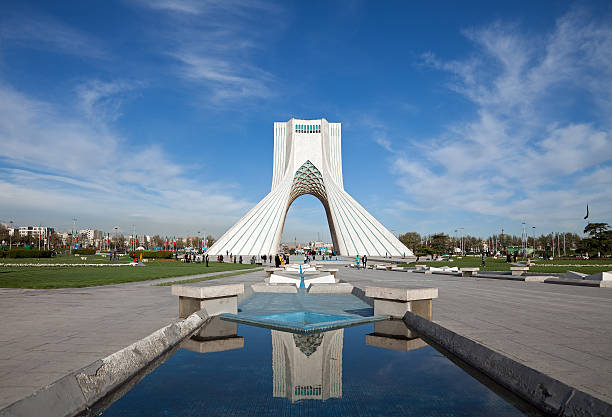 Azadi Monument and Its Reflection on Water Against Blue Sky