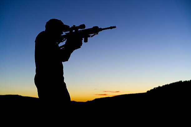istock Soldier Militia Man Holding Assault Rifle Silhoueete 620401932