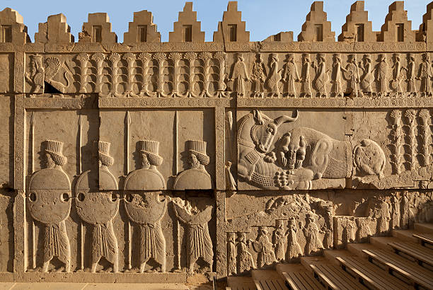 Achaemenid Carvings of Lion and Bull Beside Soldiers in Persepolis stock photo