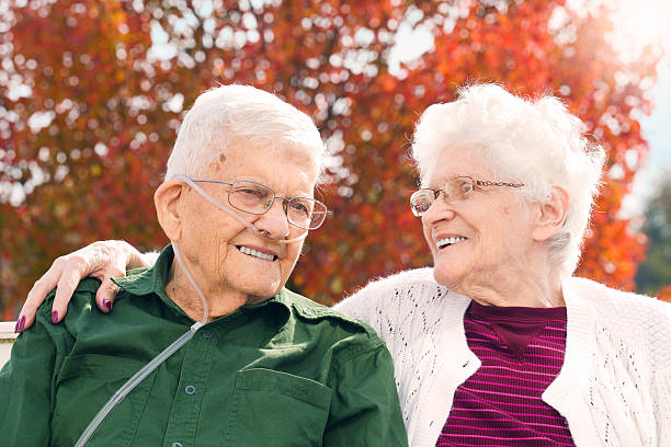 Seniors Still In Love A 92 year old man and 89 year old woman who have been married 65 years enjoying a beautiful fall day together. oxygen photos stock pictures, royalty-free photos & images