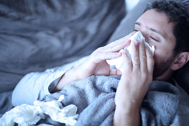 istock sick man , flu, cold and he has fever 620402780