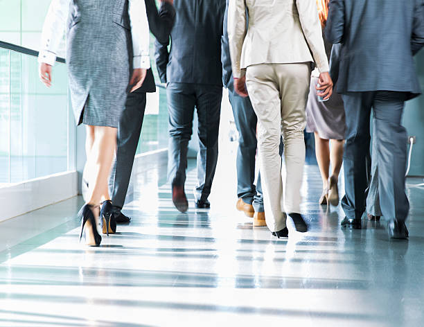 istock Group of business people walking on corridor 620404032
