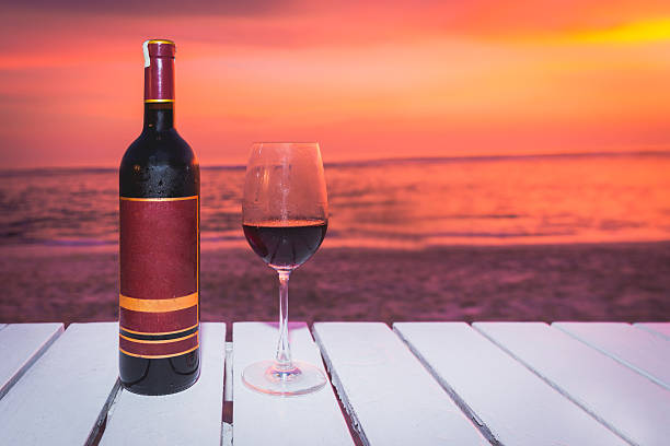 istock Wine bottle and glass with sunset backgrounds 620404562
