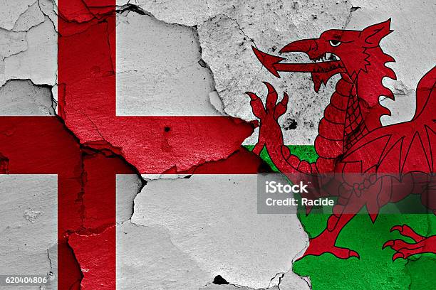 Flags Of England And Wales Painted On Cracked Wall Stock Photo - Download Image Now - Wales, England, English Flag
