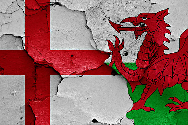 flags of england and wales painted on cracked wall - english flag fotos imagens e fotografias de stock