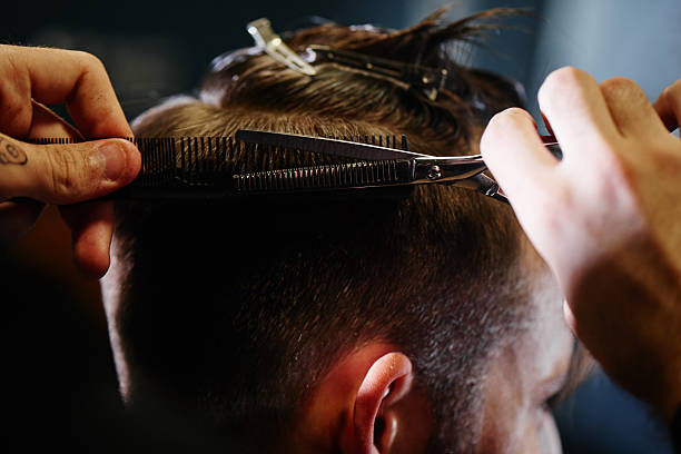 istock Hand cut with scissors the man in Barbershop closeup 620404844