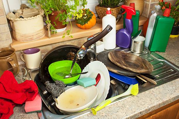 istock Cluttered dishes in the sink. Housework. 620405664