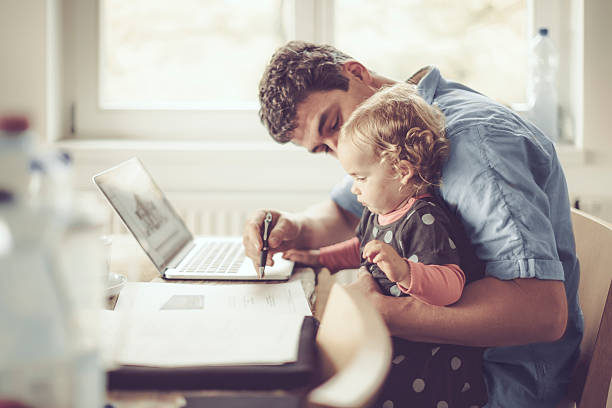 istock Fahter is showing his daughter things on a laptop 620407146