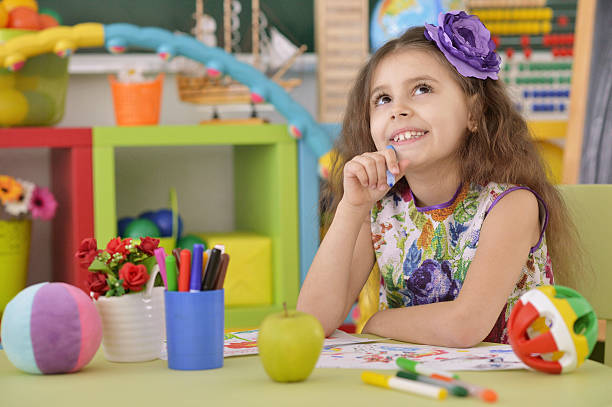 istock Little girl drawing at  class 620407342