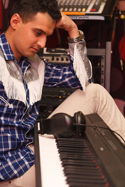 istock young handsome man near a musical instrument 620409798