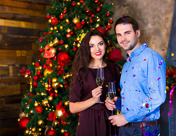 istock Young couple near fireplace celebrating Christmas 620410154