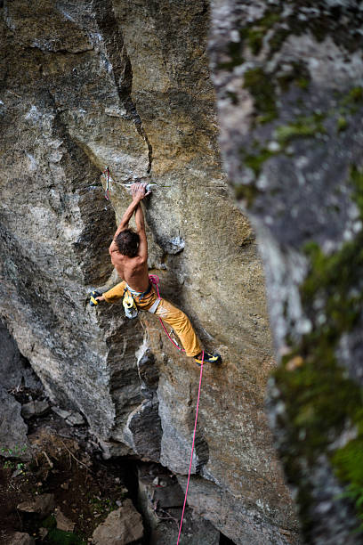 istock Extreme sport climbing. Rock climber struggle for success. 620410890