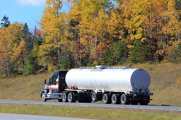 istock Semi tanker, Trailer on Interstate Highway, trees in background. 620412908